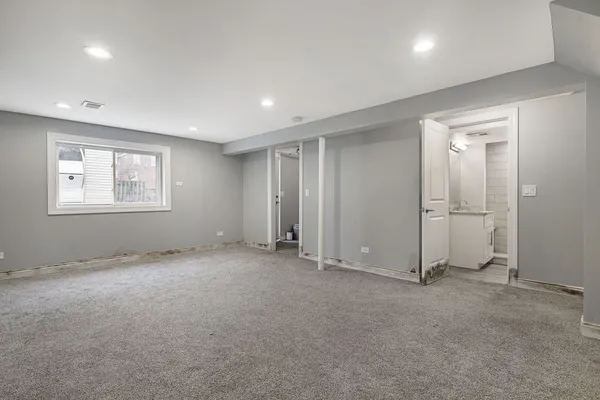 an empty room with windows and closet