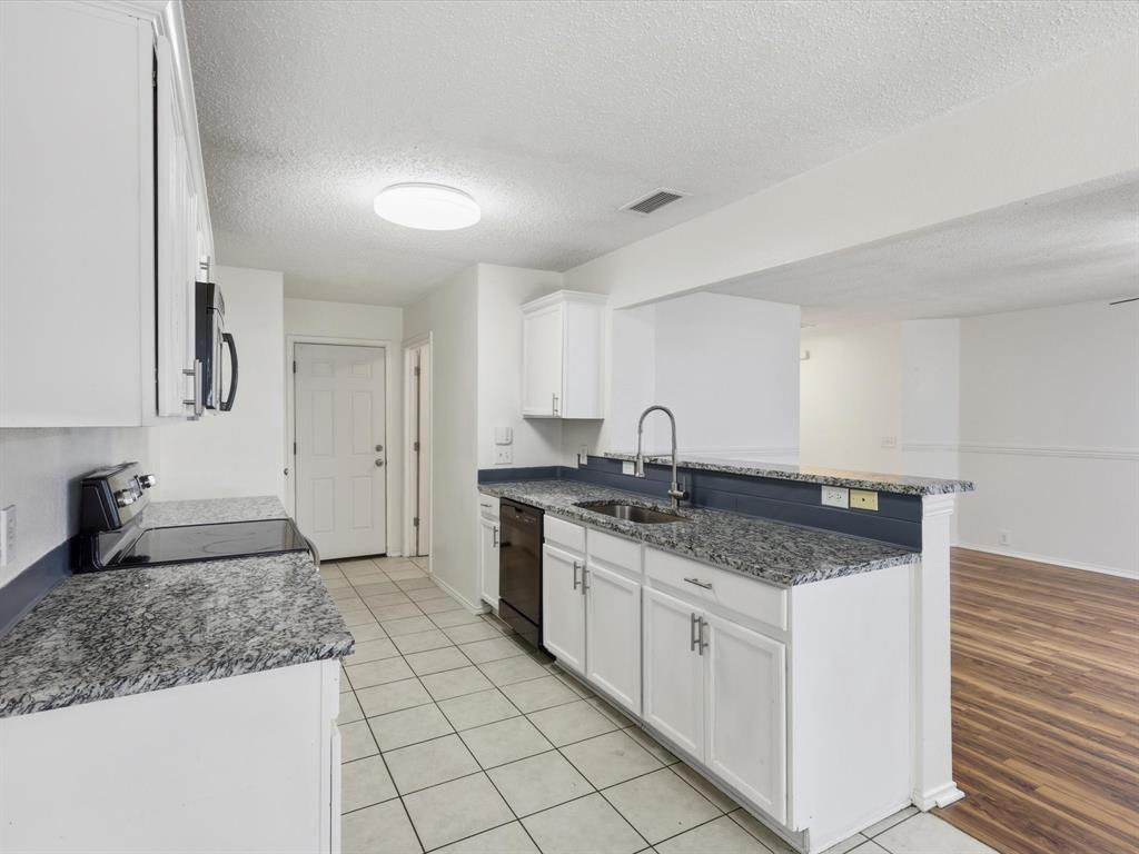 4305 Falcon Drive Sherman, TX 75092 - Photo 13 of 27 a kitchen with stainless steel appliances granite countertop a sink stove and cabinets