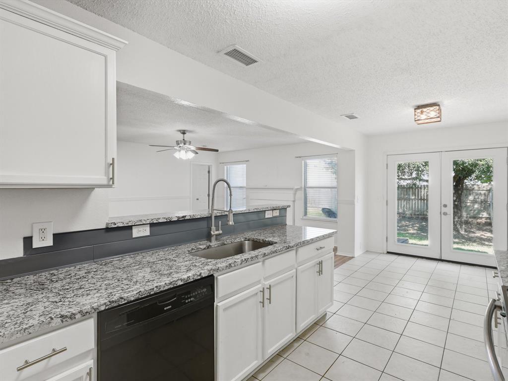 4305 Falcon Drive Sherman, TX 75092 - Photo 14 of 27 a kitchen with stainless steel appliances granite countertop a sink stove and cabinets