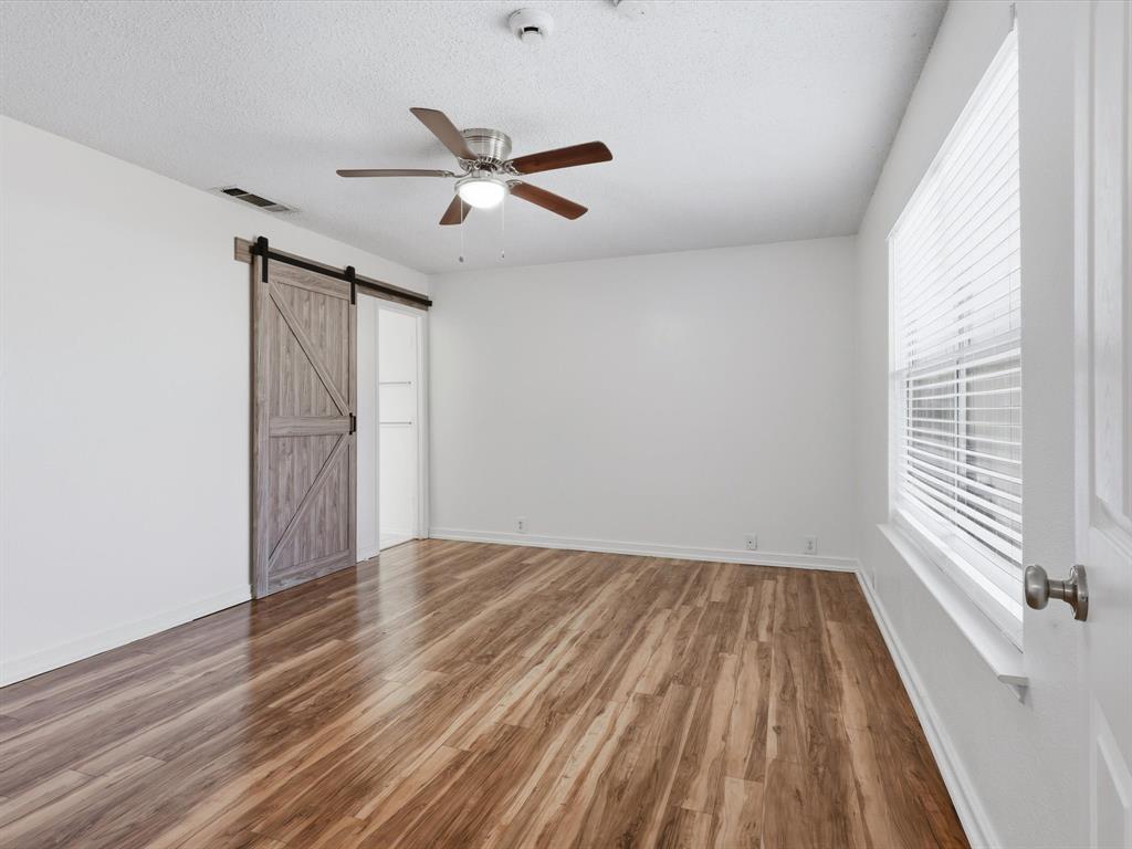 4305 Falcon Drive Sherman, TX 75092 - Photo 19 of 27 a view of empty room with wooden floor and fan