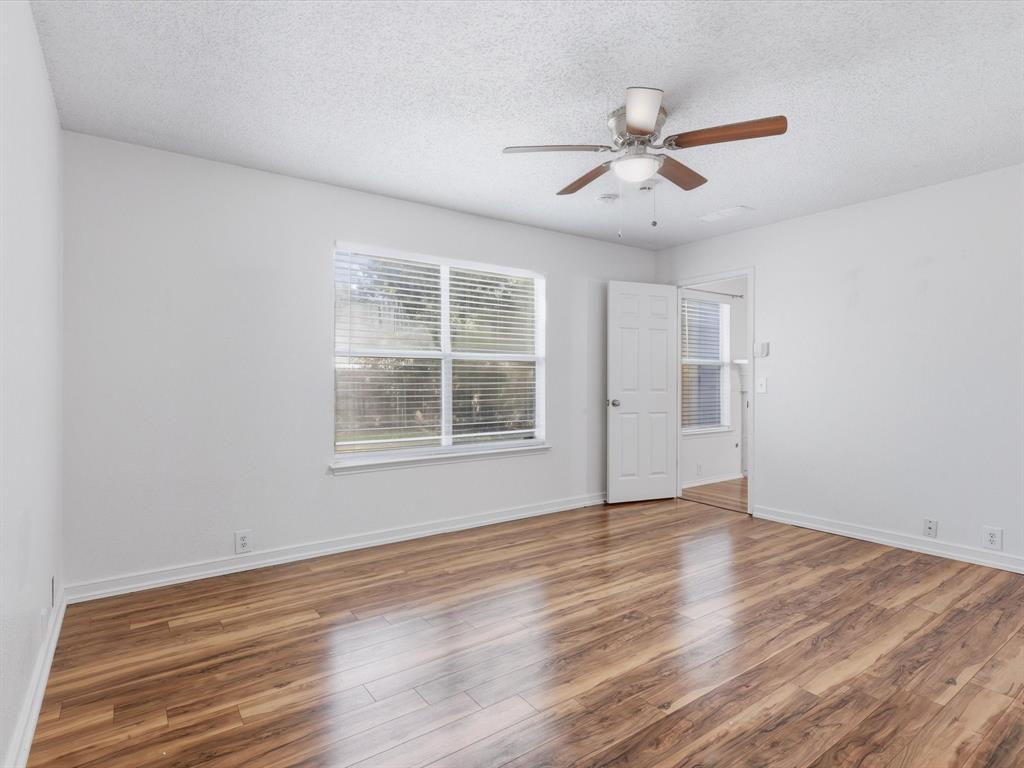 4305 Falcon Drive Sherman, TX 75092 - Photo 20 of 27 a view of an empty room with wooden floor and a window