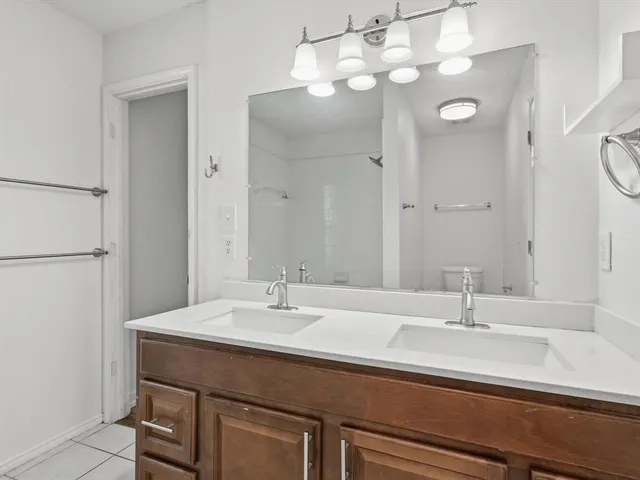 a bathroom with a sink double vanity and a mirror