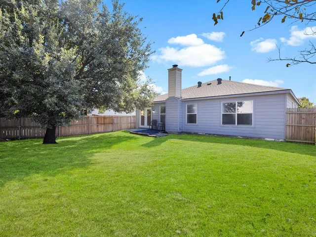 a view of a house with a backyard