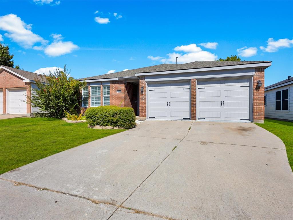 4305 Falcon Drive Sherman, TX 75092 - Photo 3 of 27 a front view of a house with a yard and garage