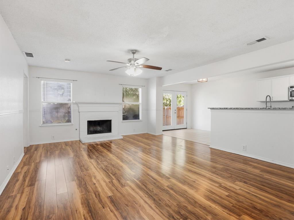 4305 Falcon Drive Sherman, TX 75092 - Photo 6 of 27 a view of empty room with wooden floor and fireplace