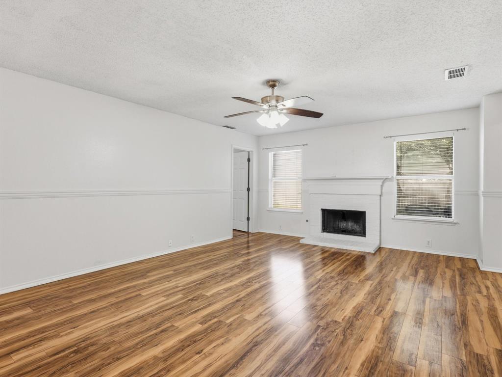4305 Falcon Drive Sherman, TX 75092 - Photo 8 of 27 a view of empty room with wooden floor and fireplace