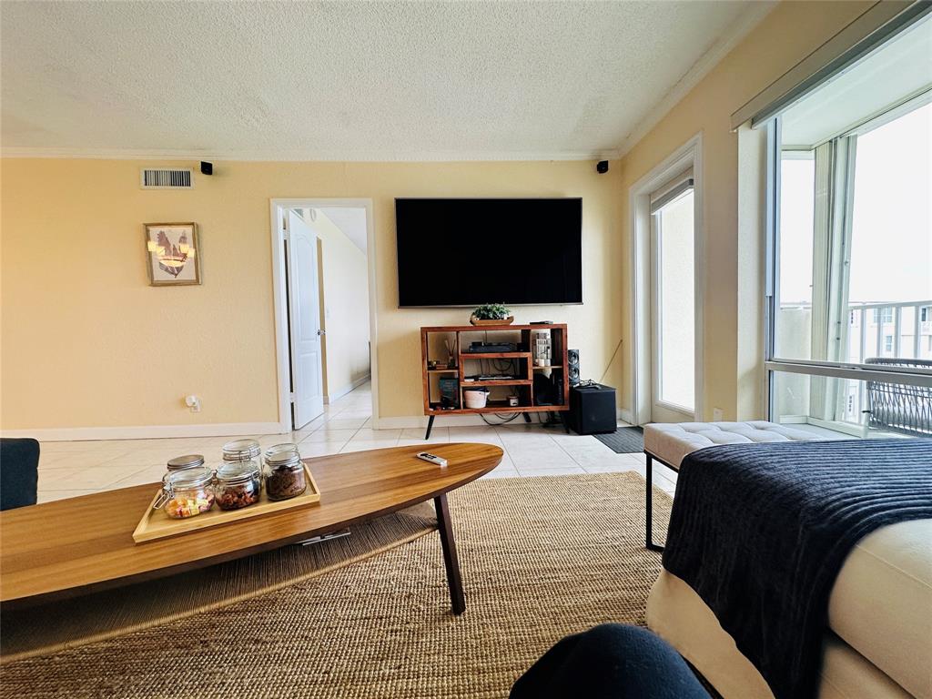 750 North Ocean Boulevard, Unit 2008 Pompano Beach, FL 33062 - Photo 11 of 64 a living room with furniture and a flat screen tv