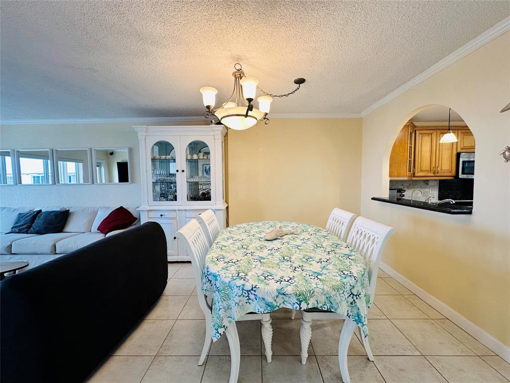 750 North Ocean Boulevard, Unit 2008 Pompano Beach, FL 33062 - Photo 14 of 64 a view of a dining room with furniture and chandelier