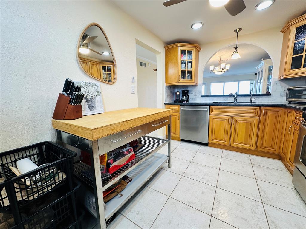 750 North Ocean Boulevard, Unit 2008 Pompano Beach, FL 33062 - Photo 18 of 64 a kitchen with stainless steel appliances granite countertop a stove a sink and a microwave