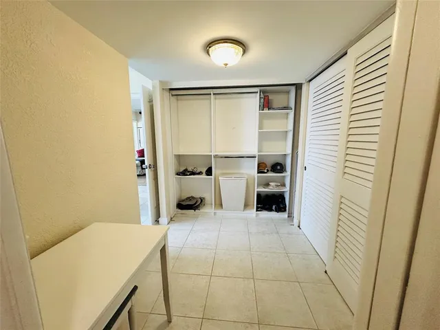 a bathroom with a granite countertop toilet sink and mirror