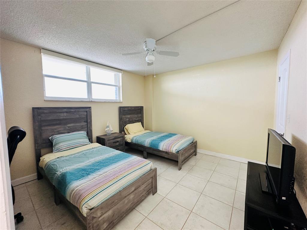 750 North Ocean Boulevard, Unit 2008 Pompano Beach, FL 33062 - Photo 28 of 64 a bedroom with double bed and a tv