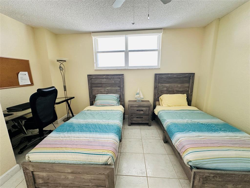 750 North Ocean Boulevard, Unit 2008 Pompano Beach, FL 33062 - Photo 29 of 64 a bedroom with two beds and a window