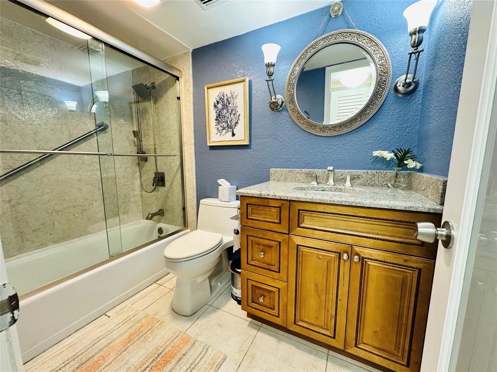 750 North Ocean Boulevard, Unit 2008 Pompano Beach, FL 33062 - Photo 30 of 64 a bathroom with a granite countertop toilet sink and mirror