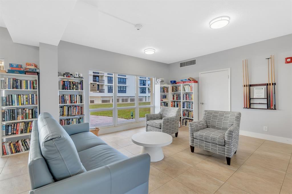 750 North Ocean Boulevard, Unit 2008 Pompano Beach, FL 33062 - Photo 36 of 64 a living room with furniture and a book shelf