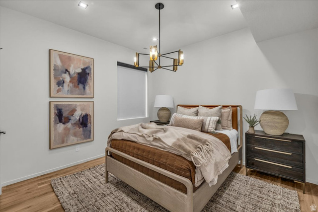 2152 South 30 West Orem, UT 84058 - Photo 35 of 56 Bedroom featuring a chandelier and light wood-style flooring