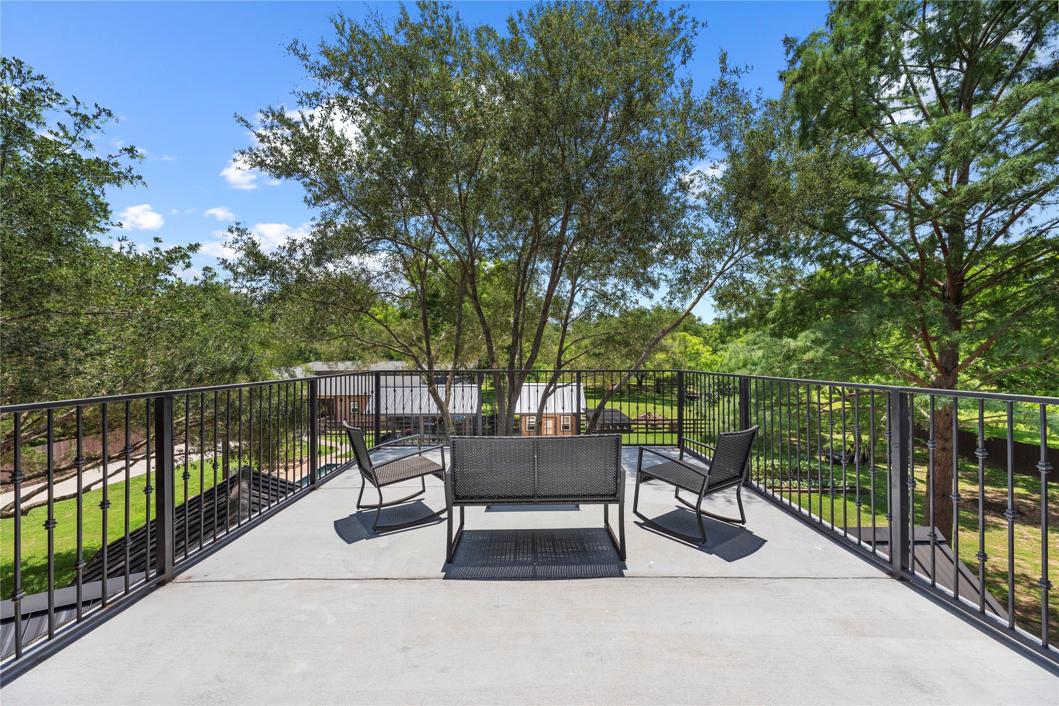 4607 Clayhead Road Richmond, TX 77406 - Photo 35 of 49 Expansive rooftop terrace offering peaceful treetop views and elevated outdoor lounging.