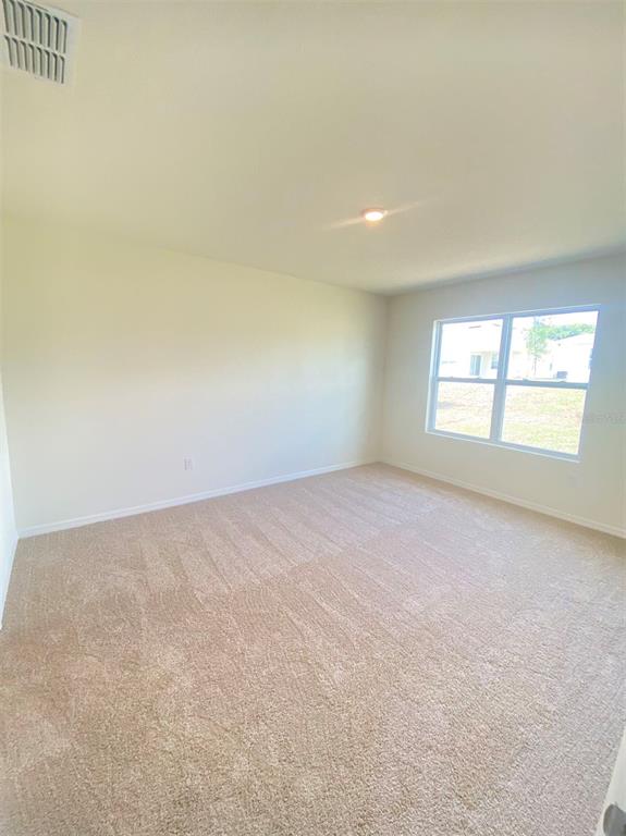 556 Talisi Loop St. Cloud, FL 34771 - Photo 12 of 16 an empty room with a window