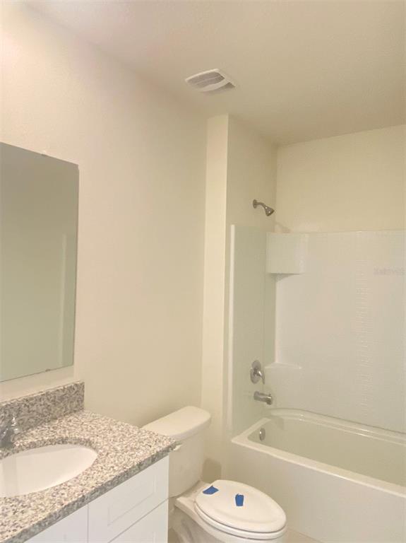 556 Talisi Loop St. Cloud, FL 34771 - Photo 6 of 16 a bathroom with a granite countertop sink toilet and shower