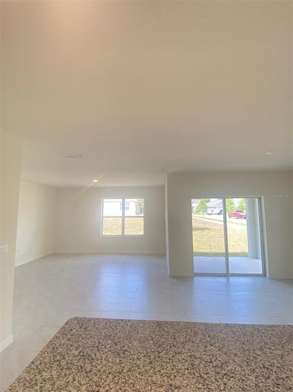 556 Talisi Loop St. Cloud, FL 34771 - Photo 7 of 16 a view of an empty room and window