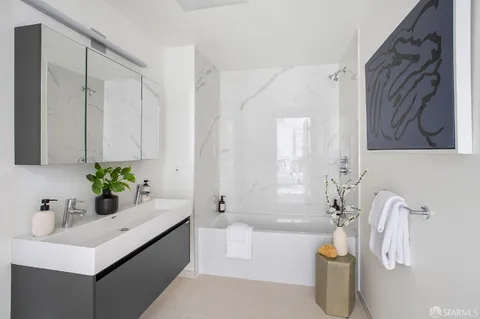 a bathroom with a sink a bathtub and a window