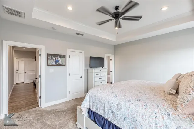 a bedroom with a bed and a ceiling fan