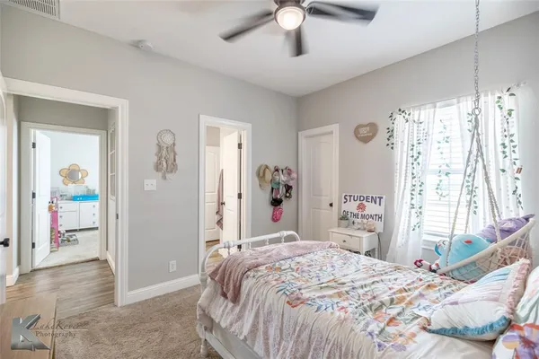 a bathroom with a toilet sink double vanity and mirror
