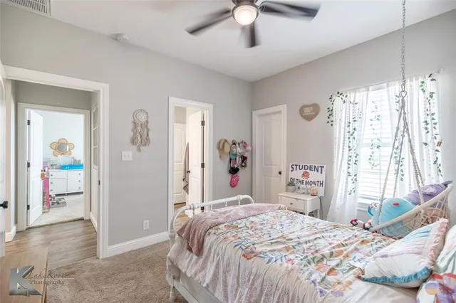 a bathroom with a toilet sink double vanity and mirror