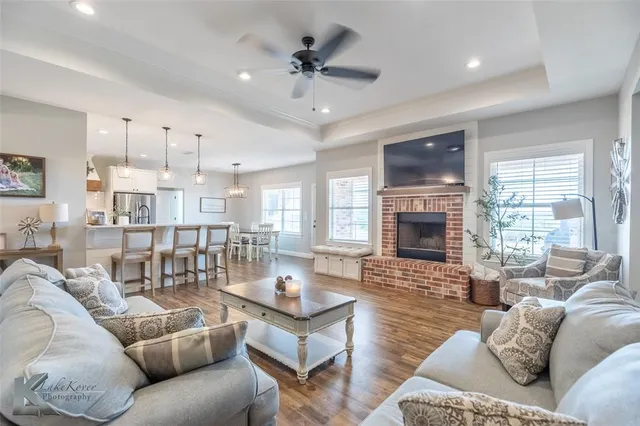 a living room with furniture a fireplace and a flat screen tv