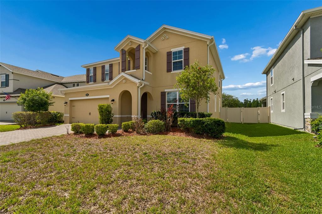 1192 Multiflora Loop Lutz, FL 33558 - Photo 5 of 32 a front view of a house with a yard