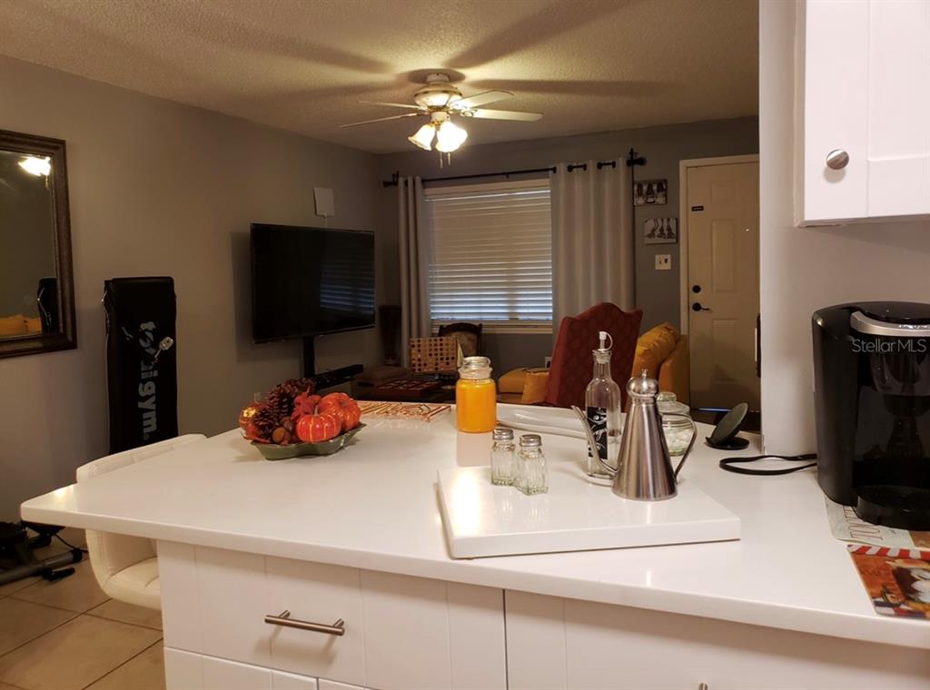 4876 Lake Ridge Road, Unit 5 Orlando, FL 32808 - Photo 4 of 11 a kitchen with a sink a stove and a refrigerator