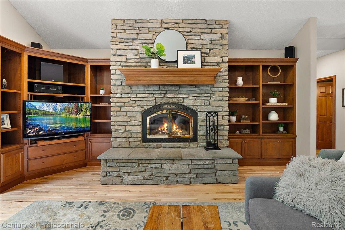 9867 Rainbow Ridge Drive Schoolcraft, MI 49087 - Photo 18 of 82 Stone fireplace with an arched firebox, hearth, and wood mantel