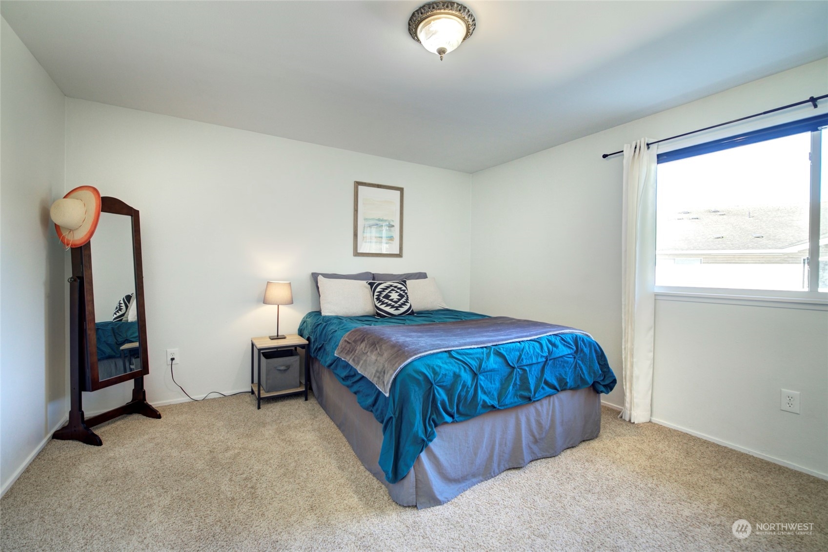 22906 Edmonds Way, Unit 15 Edmonds, WA 98020 - Photo 15 of 22 a bedroom with a bed and a window