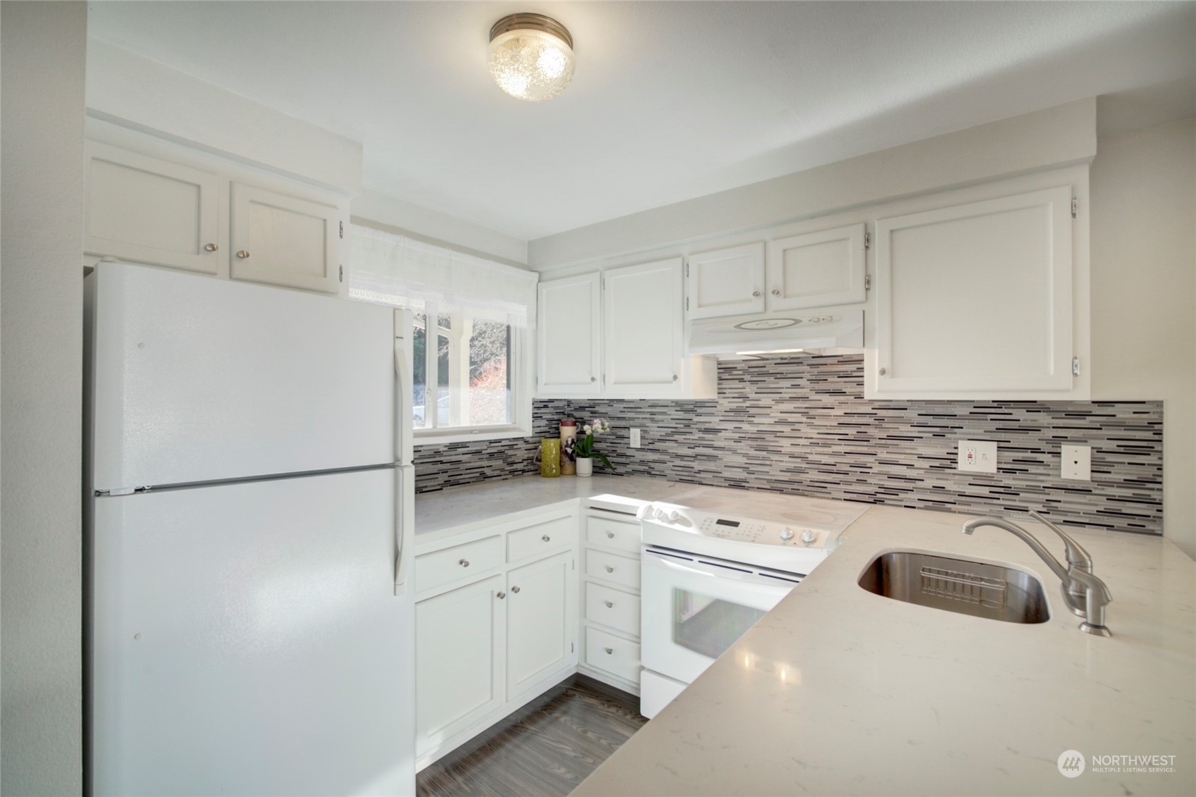 22906 Edmonds Way, Unit 15 Edmonds, WA 98020 - Photo 9 of 22 a kitchen with white cabinets and white appliances