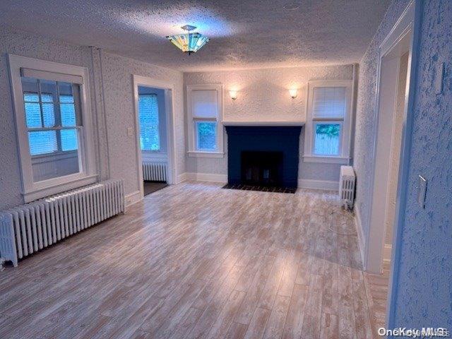11 Valley Road Bayville, NY 11709 - Photo 3 of 20 a view of an empty room with wooden floor and a window