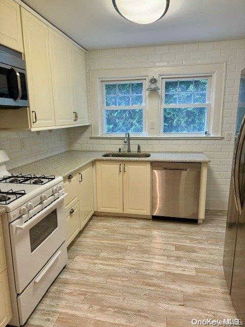 11 Valley Road Bayville, NY 11709 - Photo 5 of 20 a kitchen with stainless steel appliances granite countertop a stove a sink and a microwave