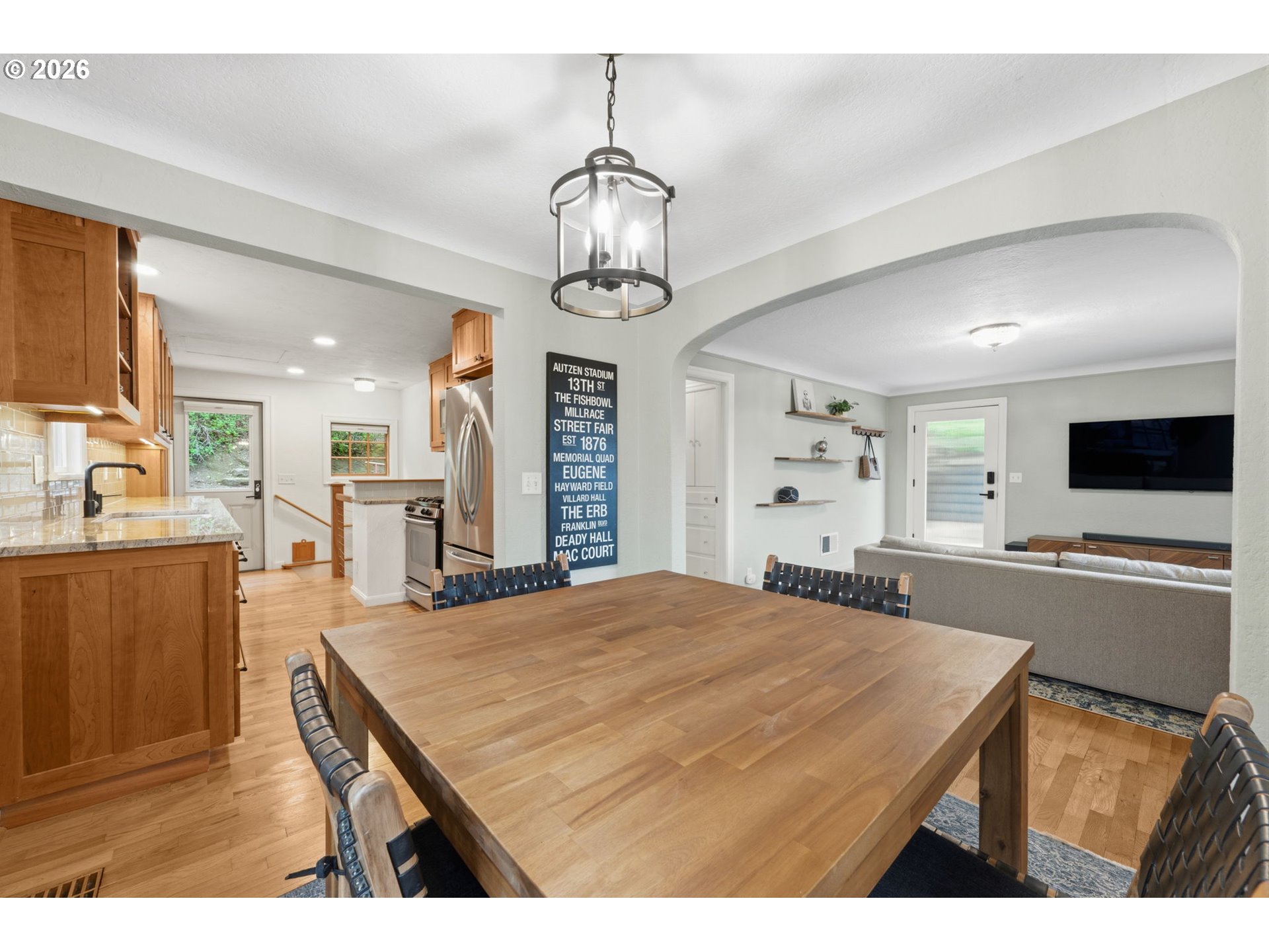 1841 Fairmount Boulevard Eugene, OR 97403 - Photo 12 of 44 a kitchen with kitchen island stainless steel appliances sink refrigerator dining table and chairs