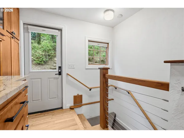a view of an entryway with wooden floor