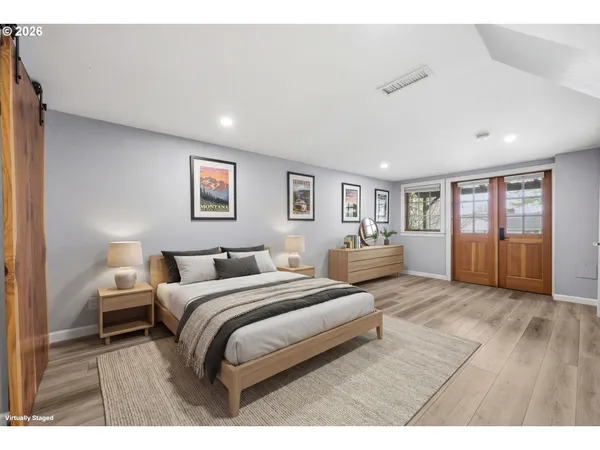 a bedroom with a large bed and a painting