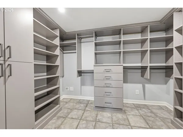 a view of walk in closet with empty racks