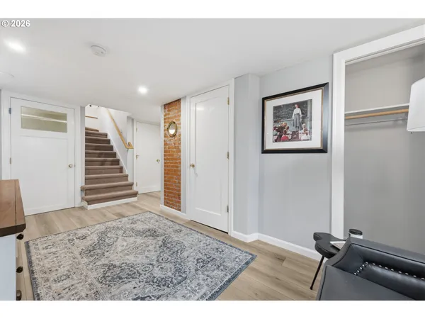 a view of room with stairs and wooden floor
