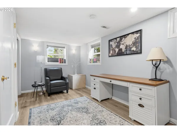 a living room with furniture and paintings on the wall
