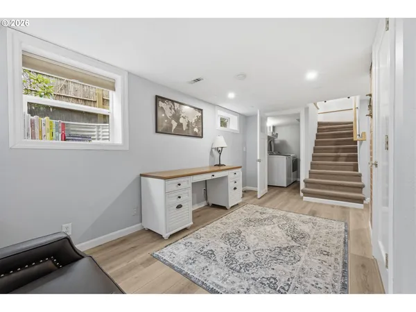 a view of workspace with wooden floor and ceiling fan