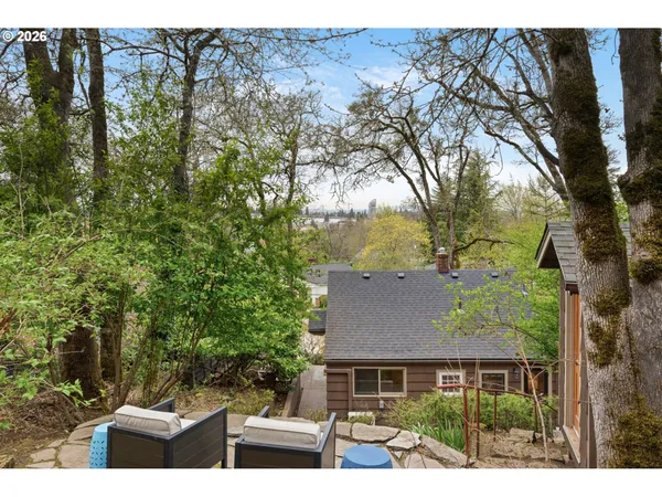 a front view of house with yard and trees around