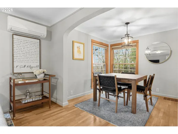 a dining room with a wooden table and chairs