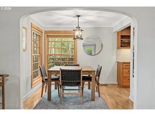 a dining room with furniture window and wooden floor
