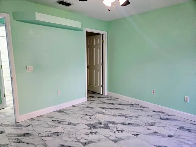 a view of a room with a sink and a mirror