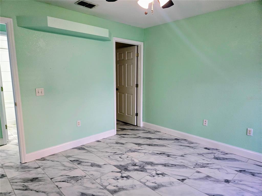 5943 Topher Trail, Unit 22 Mulberry, FL 33860 - Photo 11 of 15 a view of a room with a sink and a mirror