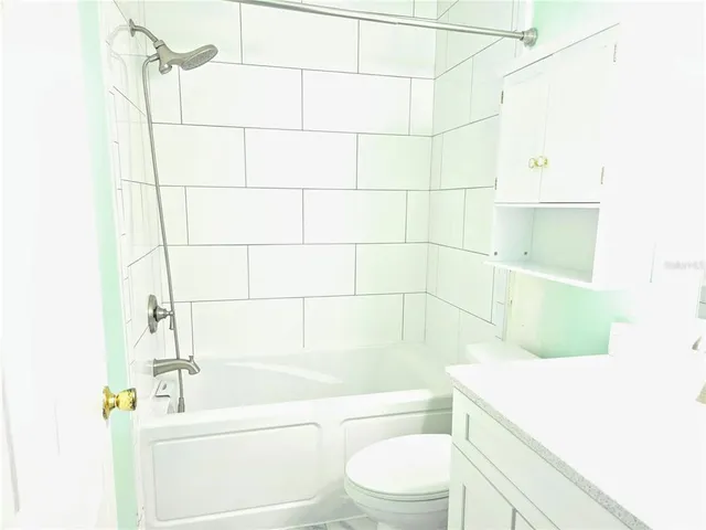 a bathroom with a bathtub and toilet