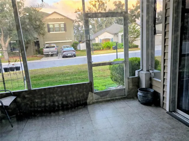 a view of a porch with furniture and garden