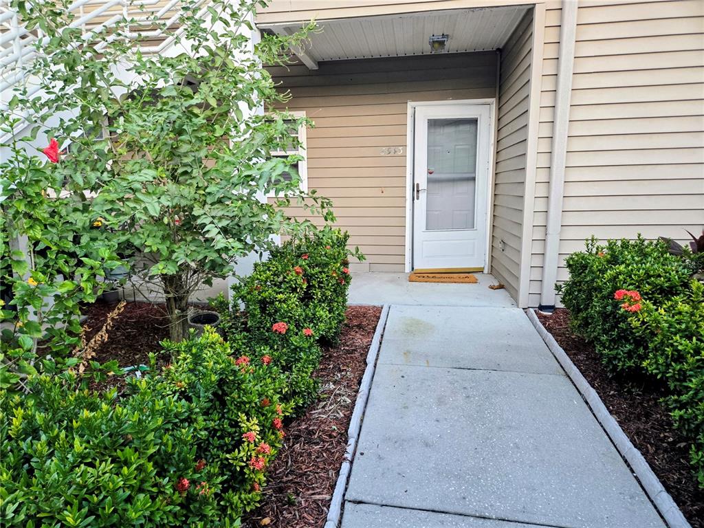 5943 Topher Trail, Unit 22 Mulberry, FL 33860 - Photo 2 of 15 a view of a backyard with potted plants